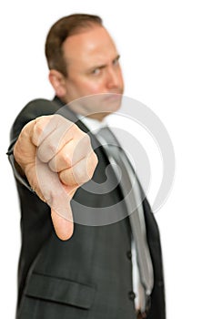 Annoyed, angry business man giving thumbs down