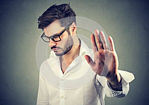 Annoyed angry man with bad attitude giving talk to hand gesture