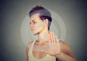 Annoyed angry man with bad attitude giving talk to hand gesture