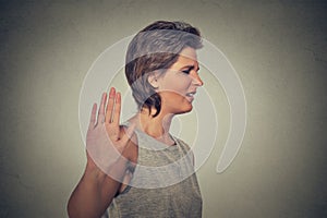 Annoyed angry woman with bad attitude giving talk to hand gesture