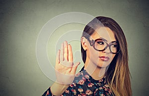 Annoyed angry woman with bad attitude giving talk to hand gesture