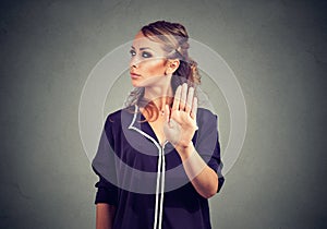 Annoyed angry woman with bad attitude giving talk to hand gesture