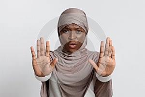 Annoyed Black Lady In Hijab Making Refuse Stop Gesture With Opened Palms