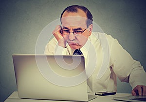 Annoyed bored man learning how to use computer