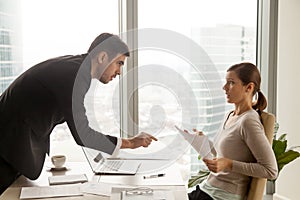 Annoyed boss arguing with female employee