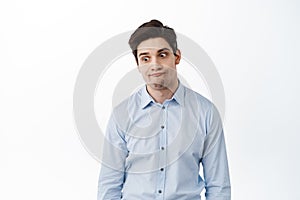 Annoyed brunette office man, manager look away irritated, tired of someone stupid, standing distressed and bothered photo