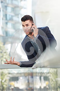 Annoyed business man talking on mobile phone