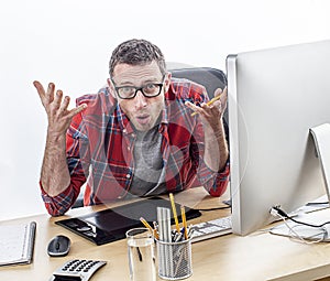 Annoyed casual business man complaining at his desk, expressing misunderstanding