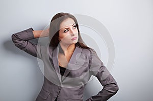 Annoyed concentration business woman in suit looking up on blue