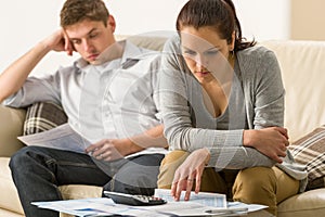 Annoyed couple calculating their finances photo