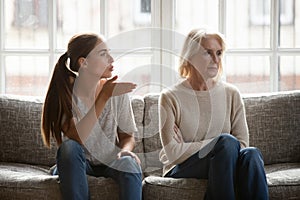 Annoyed grown up daughter expressing complaints to elderly mother