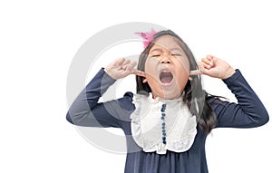 Annoyed kid sticking fingers in ears with eyes closed