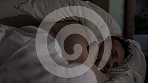 Annoyed man tossing and turning in bed unable to fall asleep, noisy neighbors photo