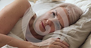 Annoyed mature woman feel frustrated suffer from insomnia in bed
