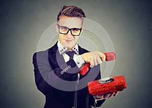 Annoyed sly young business man hanging up telephone photo