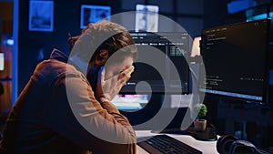 Annoyed developer exasperated after failing to remove all bugs while coding