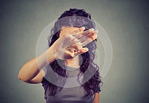 Annoyed woman covering her face with hand