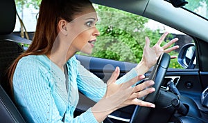 Annoyed woman driving a car
