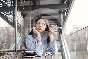 Annoyed woman holding phone to side, not listening to conversation