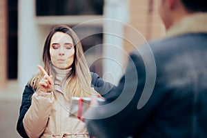 Annoyed Woman Refusing an Unwanted Gift from her Admirer