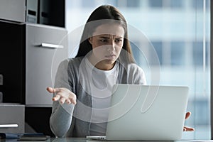 Annoyed woman secretary sitting by computer having problems with connection