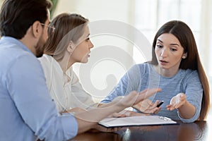 Annoyed young family couple customers dissatisfied with bad contract conditions