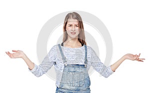 Annoyed young fashion girl in jeans overalls isolated