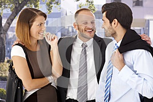 Annoying businessman celebrating with colleagues