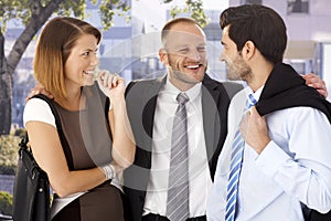 Annoying businessman celebrating with colleagues photo