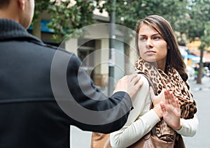 Annoying Caucasian guy chasing irritated woman