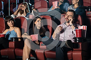 Annoying man at the movie theater photo