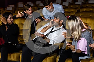 Annoying man talking on phone at movie theater