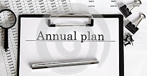 ANNUAL PLAN Conceptual background with pen and papers charts