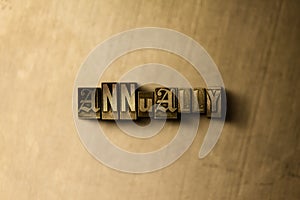 ANNUALLY - close-up of grungy vintage typeset word on metal backdrop