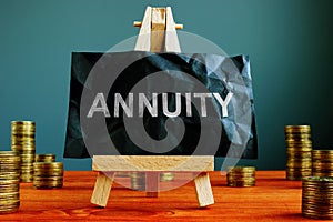 Annuity sign on the black sheet and coins photo