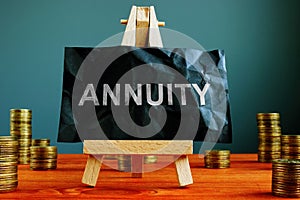 Annuity sign on the black sheet and coins