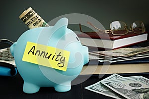 Annuity written on yellow sheet and piggy bank.