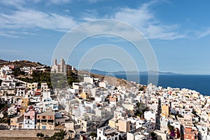 Syros island, Greece, aerial drone view. Ermoupolis and Ano Siros town cityscape, cloudy blue sky background photo