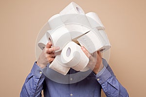 Anonym man stocking up toilet paper at home being afraid of coronavirus panic