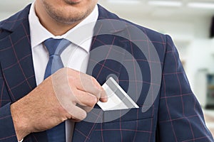 Anonymous businessman placing empty credit card photo