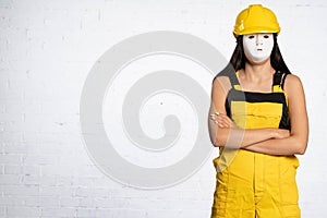 An anonymous construction worker is waiting for official orders to be issued so that she can start a new working day at