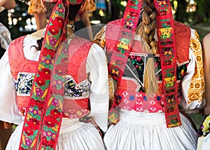Anonymous girls in folklore costumes