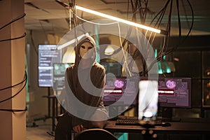 Anonymous hacker attacking database server portrait, cybercrime
