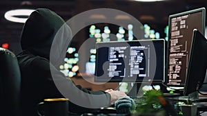 Anonymous hacker breaking cybersecurity dark room closeup. Cybercriminal reading