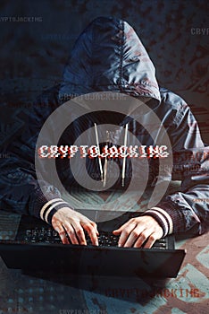 Anonymous hacker without a face is trying to steal cryptocurrency using a computer. Fraud and deception at Cryptojacking