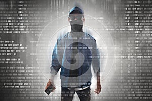 Anonymous hacker holding mobile phone