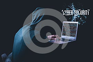Anonymous hacker with laptop in front of binary code cyber security