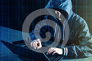 Anonymous hacker programmer uses a laptop to hack the system. Stealing personal data. Infection of malicious virus