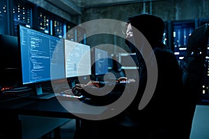 Anonymous Hacker Programming in a Server Room