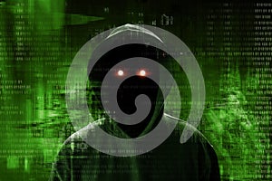 Anonymous hacker standing over binary code